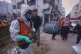 A Palestinian civil defence worker carries a human skull found during a search for bodies at a collapsed building belonging to the Salim family on Jalaa Street, targeted by Israeli strikes early in the war, in Gaza City, December 15, 2025