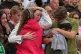 A family reacts during a menorah lighting ceremony at a floral memorial for victims of Sunday's shooting, at the Bondi Pavilion on Bondi Beach in Sydney, Australia, December 16, 2025