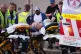 Emergency workers transport a person on a stretcher after a reported shooting at Bondi Beach in Sydney, December 14, 2025