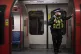 A British Transport Police officer wears a face mask on the London Underground Central line, May 2020