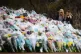 Two women look at floral tributes left at the bandstand in Clapham Common, London, for Sarah Everard, March 21, 2021