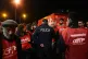 A police officer negotiates with striking workers blocking the movement of trucks at the gate to warehouses of the Portuguese postal services company, in Lisbon, December 11, 2025