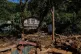 Landslide survivors look at the damages caused by the rain and landslides in Sarasavigama village in Kandy, Sri Lanka, December 1, 2025