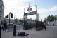 A homeless person asleep on the street beside the entrance to Westminster underground station and in the shadows of Big Ben and the Houses of Parliament in central London