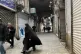 People walk as shops are closed during protests in Tehran's centuries-old main bazaar, Iran, Tuesday, Jan. 6, 2026