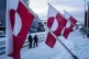 Women walk on a street in front of national flags in Nuuk, Greenland, on Wednesday, Jan. 14, 2026