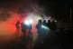 Cops stand amid tear gas at the scene of a reported shooting , in Minneapolis, January 14, 2026