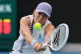 Iga Swiatek of Poland plays a backhand return to Yuan Yue of China during their first round match at the Australian Open tennis championship in Melbourne, Australia, January 19, 2026