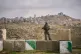An Israeli soldier stands guard during the inauguration ceremony for a new illegal Israeli settlement of Yatziv, near the Palestinian town of Beit Sahour, in the occupied West Bank, January 19, 2026