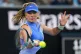 Katie Boulter of Britain plays a forehand return to Belinda Bencic of Switzerland during their first round match at the Australian Open tennis championship in Melbourne, Australia, Tuesday, Jan. 20, 2026