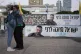 Two women embrace next to a banner with a photo of Ran Gvili after the announcement that the hostage, whose remains were the last to be recovered from Gaza, had been identified, in a plaza known as Hostages Square in Tel Aviv, Israel, January 26, 2026