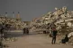 Palestinians walks amid the ruins left by the Israeli air and ground offensive in Zahra, central Gaza Strip, Wednesday, Jan. 28, 2026