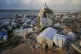 A man walks through tents sheltering displaced Palestinians amid the ruins left by the Israeli air and ground offensive in Gaza City, January 28, 2026