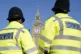Elizabeth Tower, part of the Palace of Westminster, is seen between two Metropolitan Police officers in Parliament Square, London. Picture date: Saturday March 19, 2022