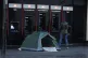 A homeless person in a tent besides cashpoint machines in Liverpool city centre, December 26, 2025