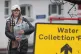 People collect bottled water at a water station in East Grinstead, after South East Water blamed bad weather for more water outages in Kent and parts of Sussex, January 13, 2026.