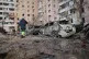 People pass by damaged cars near a block of flats after a Russian attack in Zaporizhzhia, Ukraine, January 28, 2026