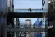 Pedestrians walk across a skybridge between commercial buildings in the Sanlitun area of Beijing, China, February 15, 2026