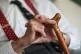 An elderly man holding his walking stick