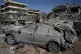 People gather near a building destroyed in an Israeli strike in the village of Bednayel in eastern Lebanon, February 21, 2026
