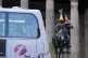 A bus passes the Duke of Wellington statue which has a traffic cone in the colours of the flag of Ukraine placed on top of the statue in front of Gallery of Modern Art (GoMA), the former mansion of Lord William Cunninghame of Lainshaw, in Glasgow, March 7, 2022