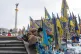 A woman place flowers at the memorial to the fallen Ukrainian soldiers on Independence Square to mark the fourth anniversary of Russia's full-scale invasion in Kyiv, Ukraine, February 24, 2026