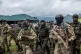 Surrounded by members of the Kenya Defence Forces (KDF), Willy Ngoma, spokesman of the M23 (centre) arrives for a ceremony to mark the withdrawal from their positions in the town of Kibumba, in the eastern of Democratic Republic of Congo, December 23, 2022