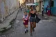 A woman accompanies a student to school in Havana, Cuba, Friday, March 13, 2026