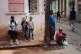 People hang out on the sidewalk during a blackout in Havana, March 17, 2026