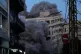 A building collapses as smoke rises following an Israeli strike in central Beirut, Lebanon, March 18, 2026