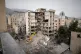 Iranian Red Crescent emergency workers use a bulldozer to clear rubble from a residential building that was hit in an earlier U.S.-Israeli strike in Tehran, Iran, March 23, 2026