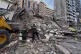 Civil defense workers check a destroyed building that was hit by an Israeli airstrike in Dahiyeh, Beirut's southern suburbs, Lebanon, March 24, 2026