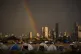 Displaced people who fled Israeli strikes in southern Lebanon sit inside tents used as shelters as a rainbow breaks through the rain in Beirut, Lebanon, Sunday, March 29, 2026
