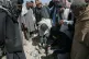 Residents and Taliban police gather the remains of a projectile at the site of a strike in Kabul, Afghanistan, March 13, 2026