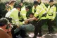 Police restrain Campaign Against Arms Trade protesters at the entrance to Farnborough airfield, hosting Britain's biggest annual arms fair, September 1, 1997