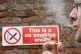 A member of public smokes a cigarette