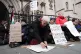 Protesters write on placards outside the High Court, central London, February 13, 2026