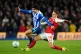 Brighton and Hove Albion's Ferdi Kadioglu (left) and Arsenal's Leandro Trossard battle for the ball during the Premier League match at the American Express Stadium, Brighton, March 4 2026