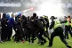 Police officer and stewards force fans back after they invaded the pitch following a penalty shoot out after the Scottish Gas Men's Scottish Cup quarter-final match at Ibrox Stadium, Glasgow, March 8, 2026