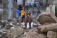 Local residents navigate through the rubble of boundary wall collapsed due to heavy rains and strong winds in Karachi, Pakistan, March 19, 2026