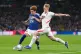 Japan's Kaishu Sano (left) and England's Lewis Hall challenge for the ball during the International friendly soccer match between England and Japan in London, March 31, 2026