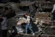 A woman holds her dog as she walks past burned cars a day after an Israeli air strike in Beirut, Lebanon, April 9, 2026