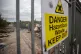 Warning signs on the gates of Broadway Industrial Estate, August 1, 2025