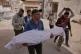 Mohamed Ayad carries the body of his nephew Saleh Badawi 12, who was killed by Israeli fire during his funeral outside Shifa Hospital, in Gaza City, April 17, 2026