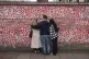 A group of people comfort each other during a service at the National Covid Memorial Wall in London during the annual national Covid-19 day of reflection, March 8, 2026