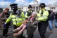 Police remove a protester at a demonstration against the ban on Palestine Action, in Trafalgar Square, central London, April 11, 2026