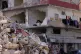 A woman hangs laundry in her damaged apartment after returning home with her family in the southern port city of Tyre, Lebanon, April 30, 2026