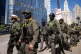 Federal agents from US Immigration and Customs Enforcement (Ice) and US Customs and Border Protection walk along West Wacker Drive in the Loop in Chicago, September 28, 2025