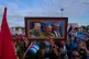 A marcher holds a framed composite image of Fidel Castro, Raul Castro and Cuba's President Miguel Diaz-Canel, during the May Day parade at Revolution Square in Havana, May 1, 2025