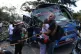 Relatives of victims embrace in front of a bus hit by an explosive device on the Pan-American Highway in Cajibio, Colombia, April 25, 2026, after an attack blamed by authorities on dissident groups of the former FARC rebels killed at least a dozen people